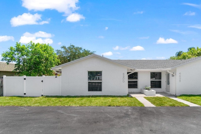4498 NW 2nd Ave, Boca Raton, FL 33431 - view of front of house featuring stucco siding and a gate