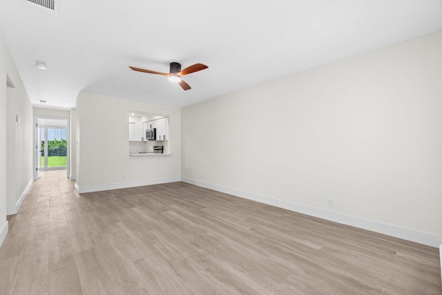 4498 NW 2nd Ave, Boca Raton, FL 33431 - unfurnished living room with ceiling fan, light wood finished floors, and baseboards