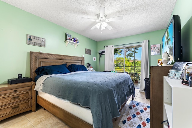 bedroom featuring light tile patterned flooring, a textured ceiling, ceiling fan, and access to exterior