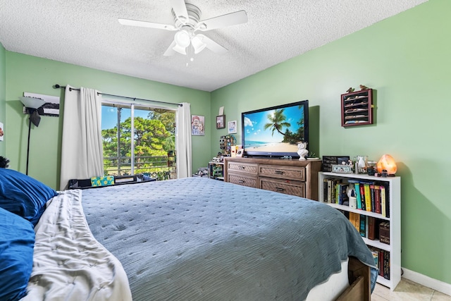bedroom featuring a textured ceiling, ceiling fan, light tile patterned floors, and baseboards
