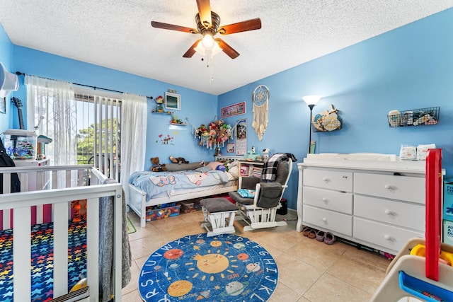 bedroom with tile patterned flooring, a textured ceiling, and ceiling fan