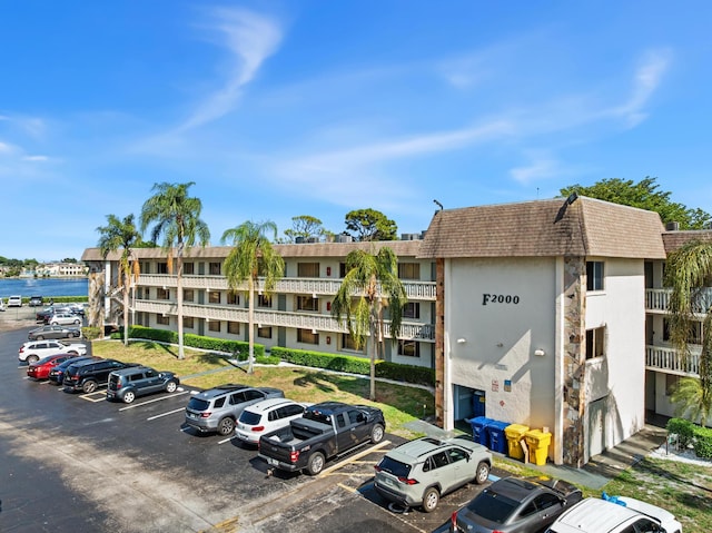 view of building exterior featuring uncovered parking