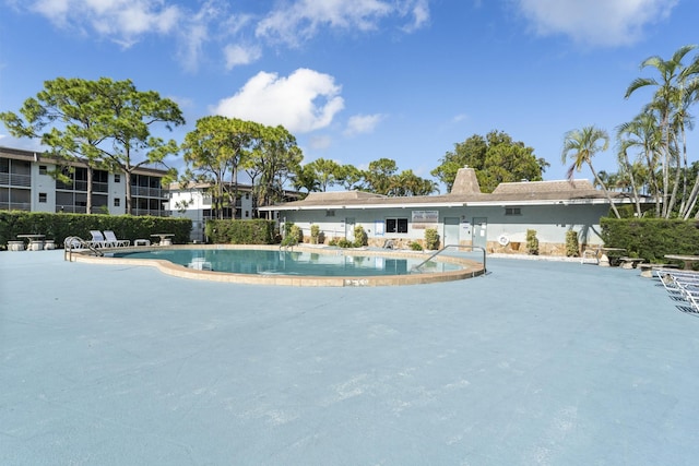 community pool with a patio area