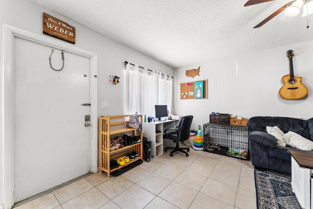 office with ceiling fan, light tile patterned floors, and a textured ceiling