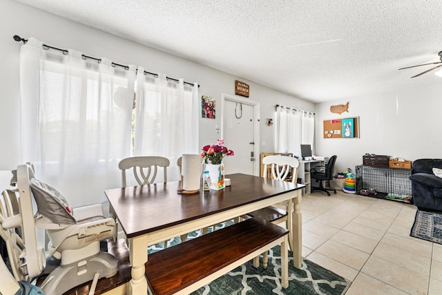 dining room with ceiling fan, light tile patterned floors, a textured ceiling, and a desk