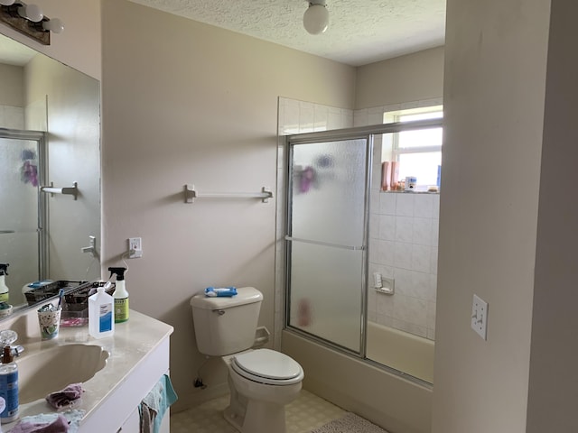 1472 SW Melrose Ave, Port Saint Lucie, FL 34953 - full bath with vanity, toilet, bath / shower combo with glass door, and a textured ceiling