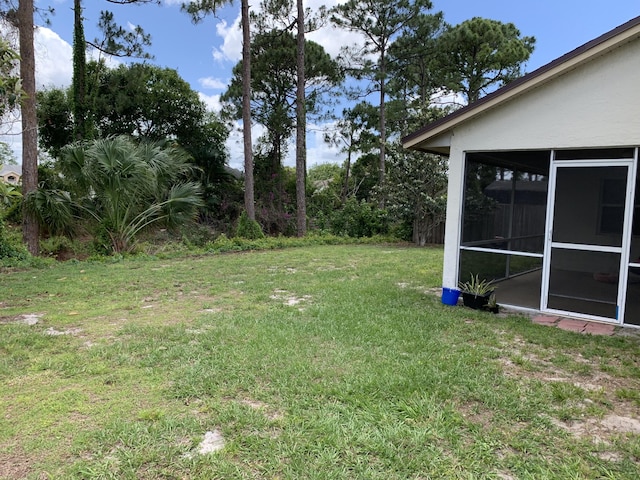 1472 SW Melrose Ave, Port Saint Lucie, FL 34953 - view of grassy yard with a sunroom