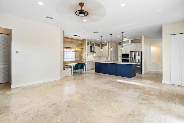 4205 Artesa Dr, Boynton Beach, FL 33436 - kitchen featuring stainless steel appliances, light countertops, wall chimney exhaust hood, baseboards, and glass insert cabinets