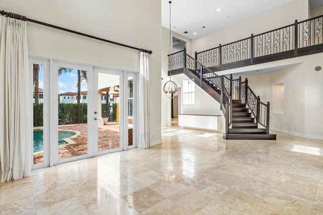 4205 Artesa Dr, Boynton Beach, FL 33436 - entryway with a high ceiling, baseboards, stairway, recessed lighting, and a chandelier