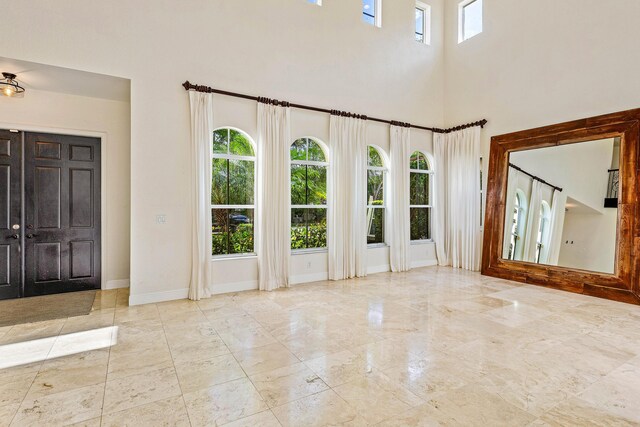 4205 Artesa Dr, Boynton Beach, FL 33436 - foyer with marble tiled floors, a towering ceiling, and baseboards