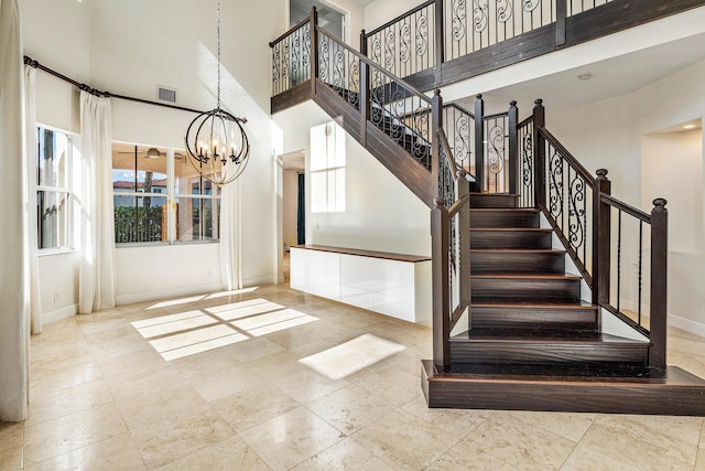 4205 Artesa Dr, Boynton Beach, FL 33436 - stairs with a towering ceiling, baseboards, and a chandelier