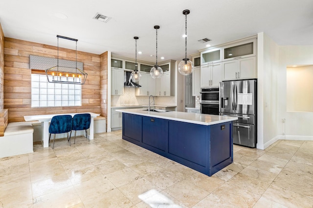 4205 Artesa Dr, Boynton Beach, FL 33436 - kitchen with stainless steel appliances, a sink, wall chimney range hood, light countertops, and backsplash