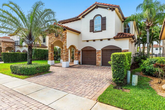 4205 Artesa Dr, Boynton Beach, FL 33436 - mediterranean / spanish-style home with a tiled roof, decorative driveway, a garage, and stucco siding