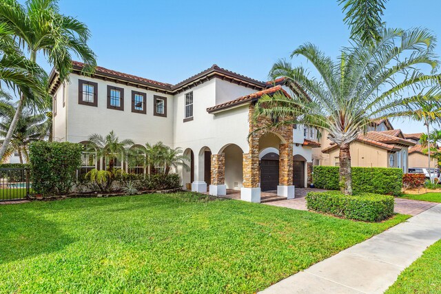 4205 Artesa Dr, Boynton Beach, FL 33436 - mediterranean / spanish house with stucco siding, a garage, a tile roof, and driveway