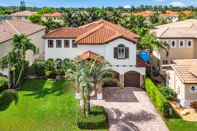 4205 Artesa Dr, Boynton Beach, FL 33436 - mediterranean / spanish home with stucco siding, a tile roof, a residential view, a front lawn, and driveway
