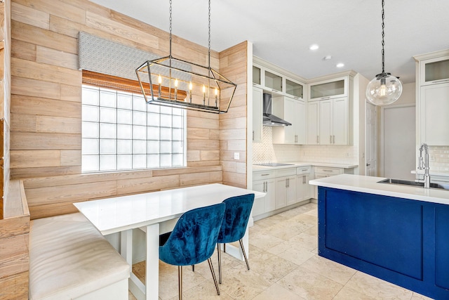 4205 Artesa Dr, Boynton Beach, FL 33436 - kitchen featuring a sink, wall chimney exhaust hood, a chandelier, backsplash, and black electric cooktop