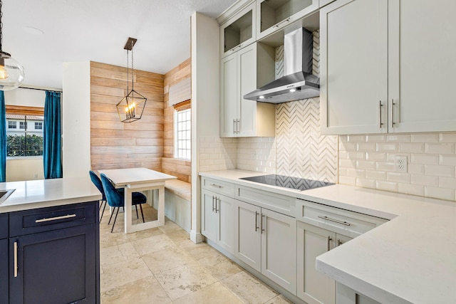 4205 Artesa Dr, Boynton Beach, FL 33436 - kitchen with wall chimney range hood, decorative backsplash, plenty of natural light, light countertops, and wood walls