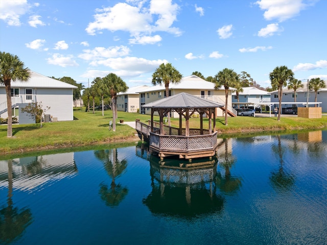 210 SE Village Dr Unit 210, Port Saint Lucie, FL 34952 - dock area with a gazebo, a water view, a yard, and a residential view
