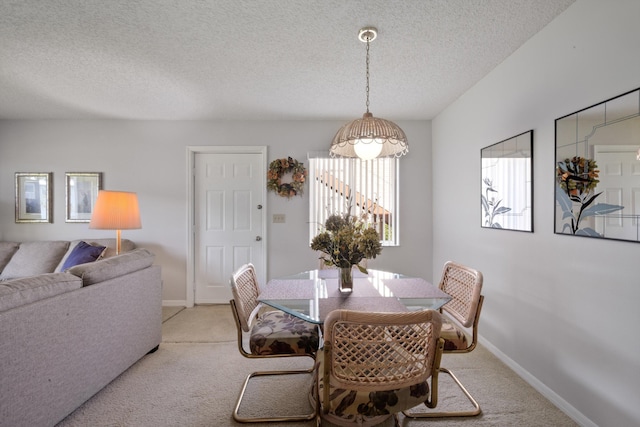 210 SE Village Dr Unit 210, Port Saint Lucie, FL 34952 - dining area with light carpet, a textured ceiling, and baseboards