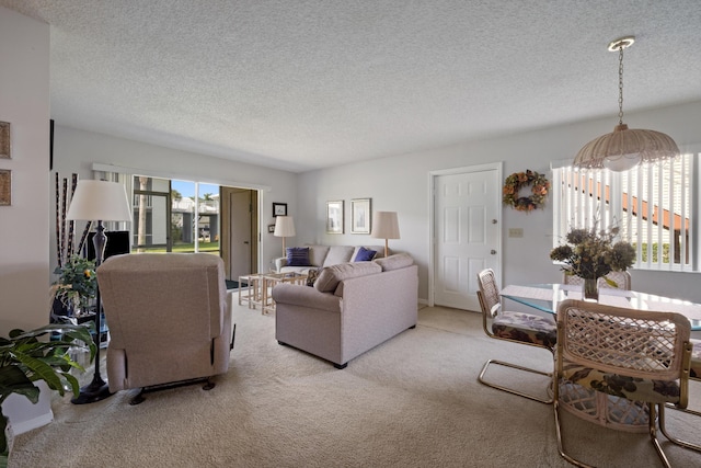 210 SE Village Dr Unit 210, Port Saint Lucie, FL 34952 - carpeted living area with a textured ceiling and a chandelier
