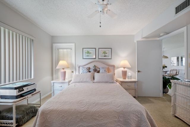 210 SE Village Dr Unit 210, Port Saint Lucie, FL 34952 - bedroom with light colored carpet, a textured ceiling, and a ceiling fan