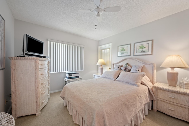 210 SE Village Dr Unit 210, Port Saint Lucie, FL 34952 - bedroom with light colored carpet, a textured ceiling, ceiling fan, and baseboards