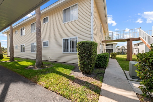 210 SE Village Dr Unit 210, Port Saint Lucie, FL 34952 - view of home's exterior featuring a yard