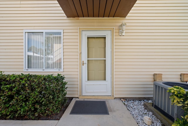 210 SE Village Dr Unit 210, Port Saint Lucie, FL 34952 - doorway to property featuring cooling unit