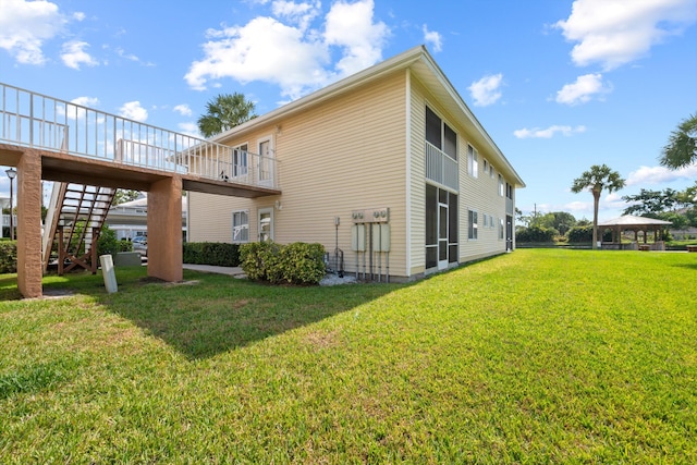 210 SE Village Dr Unit 210, Port Saint Lucie, FL 34952 - back of property featuring a gazebo, stairs, and a lawn