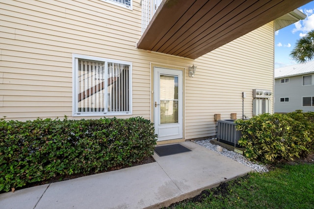 210 SE Village Dr Unit 210, Port Saint Lucie, FL 34952 - property entrance featuring a patio and central AC unit