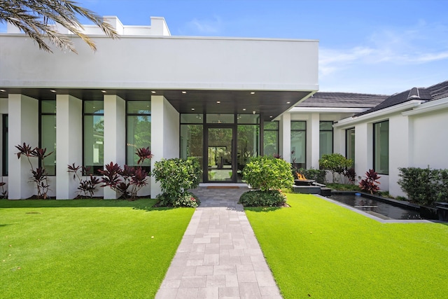 18074 Sentinel Cir, Boca Raton, FL 33496 - entrance to property featuring stucco siding, a lawn, and french doors