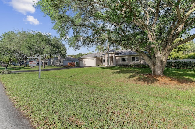 5320 SW 199th Ave, Pembroke Pines, FL 33332 - view of front of home with asphalt driveway, an attached garage, a front lawn, and stucco siding