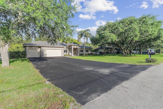 5320 SW 199th Ave, Pembroke Pines, FL 33332 - view of front of house with asphalt driveway, a garage, and a front yard