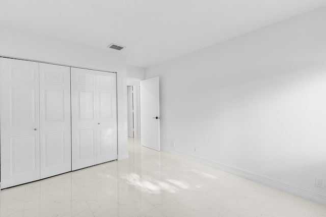5320 SW 199th Ave, Pembroke Pines, FL 33332 - unfurnished bedroom with light marble finish flooring, a closet, and baseboards