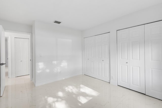 5320 SW 199th Ave, Pembroke Pines, FL 33332 - unfurnished bedroom with multiple closets, marble finish flooring, and baseboards