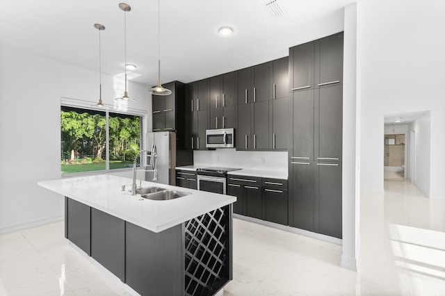 5320 SW 199th Ave, Pembroke Pines, FL 33332 - kitchen with appliances with stainless steel finishes, a sink, light countertops, a center island with sink, and dark cabinetry