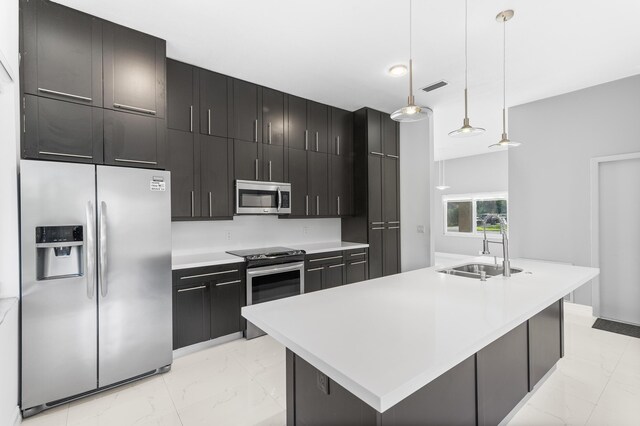 5320 SW 199th Ave, Pembroke Pines, FL 33332 - kitchen with stainless steel appliances, light marble finish flooring, a sink, light countertops, and dark cabinetry