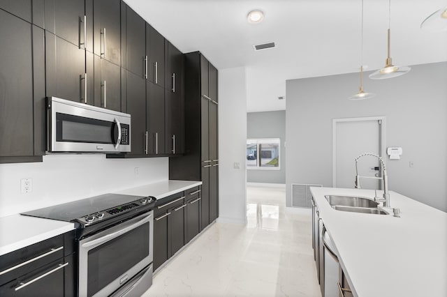 5320 SW 199th Ave, Pembroke Pines, FL 33332 - kitchen with appliances with stainless steel finishes, a sink, light marble finish flooring, dark cabinets, and hanging light fixtures