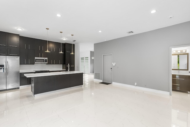 5320 SW 199th Ave, Pembroke Pines, FL 33332 - kitchen with stainless steel appliances, a sink, light countertops, light marble finish floors, and a kitchen island with sink