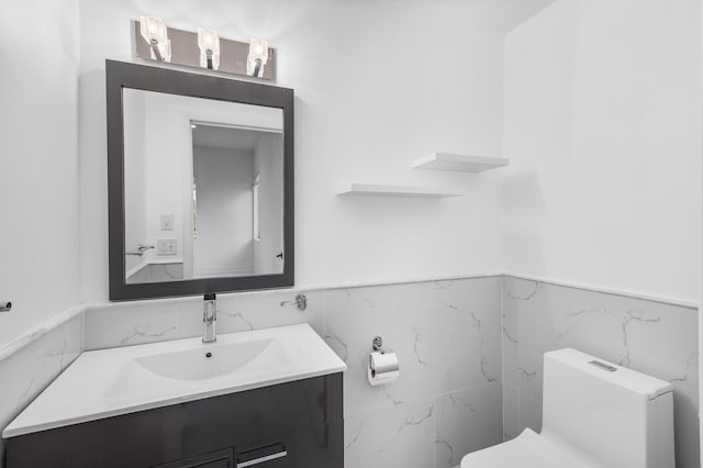 5320 SW 199th Ave, Pembroke Pines, FL 33332 - bathroom with tile walls, wainscoting, toilet, and vanity