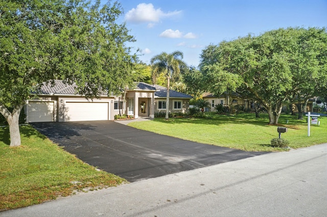 5320 SW 199th Ave, Pembroke Pines, FL 33332 - view of front of house featuring asphalt driveway, a front lawn, a garage, and stucco siding