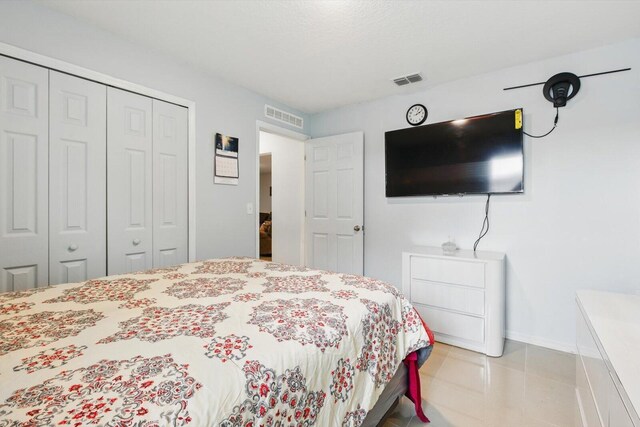 482 NW Fairfax Ave, Port Saint Lucie, FL 34983 - bedroom with a closet, baseboards, and light tile patterned floors