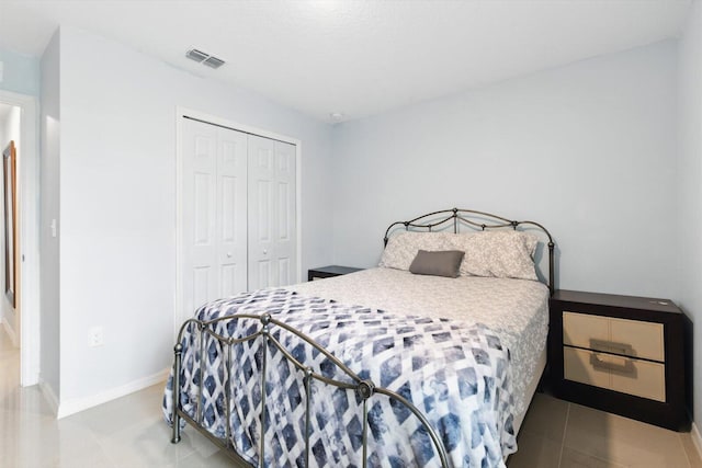 482 NW Fairfax Ave, Port Saint Lucie, FL 34983 - bedroom featuring a closet, baseboards, and tile patterned flooring