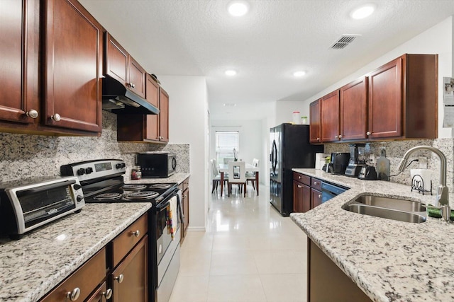 482 NW Fairfax Ave, Port Saint Lucie, FL 34983 - kitchen with black appliances, a sink, under cabinet range hood, tasteful backsplash, and recessed lighting