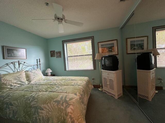5155 Europa Dr Unit R, Boynton Beach, FL 33437 - carpeted bedroom featuring a ceiling fan, baseboards, and a textured ceiling