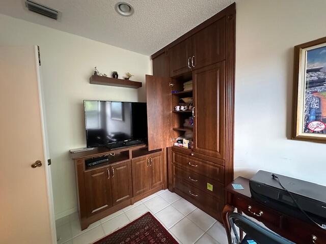 5155 Europa Dr Unit R, Boynton Beach, FL 33437 - living room with light tile patterned floors, a textured ceiling, and an office area