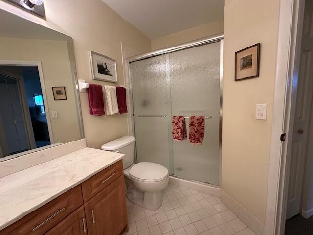 5155 Europa Dr Unit R, Boynton Beach, FL 33437 - full bath featuring a stall shower, vanity, tile patterned flooring, and toilet