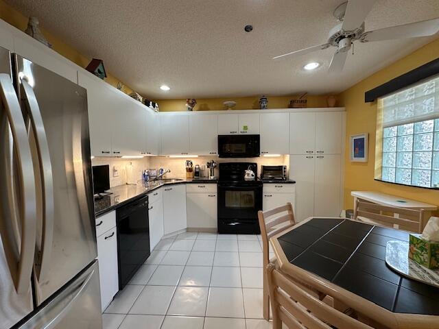 5155 Europa Dr Unit R, Boynton Beach, FL 33437 - kitchen featuring black appliances, recessed lighting, a ceiling fan, white cabinetry, and a sink