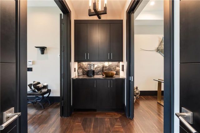 bar featuring decorative backsplash and baseboards