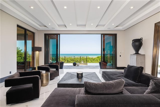 living room with marble tiled floors, a water view, and recessed lighting